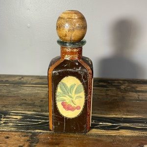 Made in Italy alcohol decanter leather wrapped.  Wooden top split.